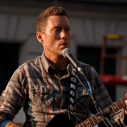 Jamie singing and playing guitar